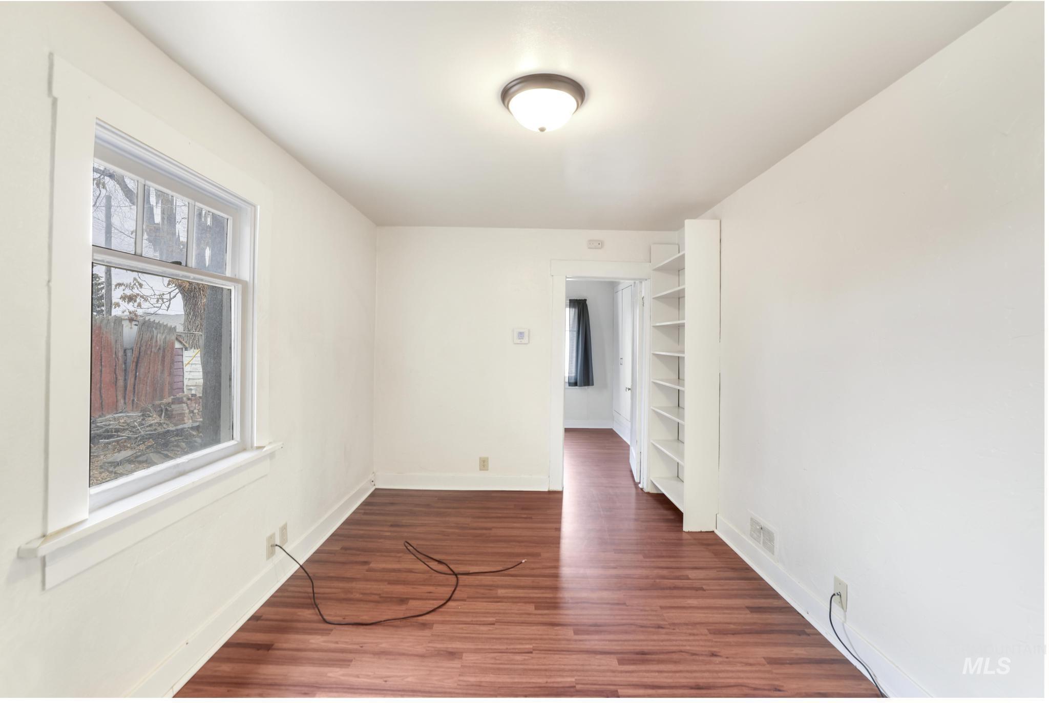 250 Elm Street Twin Falls, ID 83301 - Photo 12 of 28 Spare room with dark wood-style flooring and baseboards