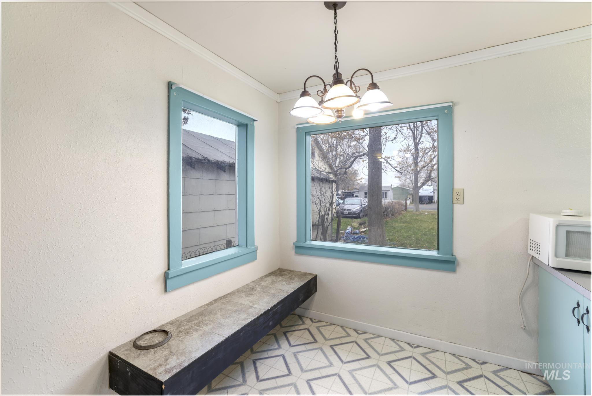 250 Elm Street Twin Falls, ID 83301 - Photo 18 of 28 Dining area featuring a chandelier and crown molding