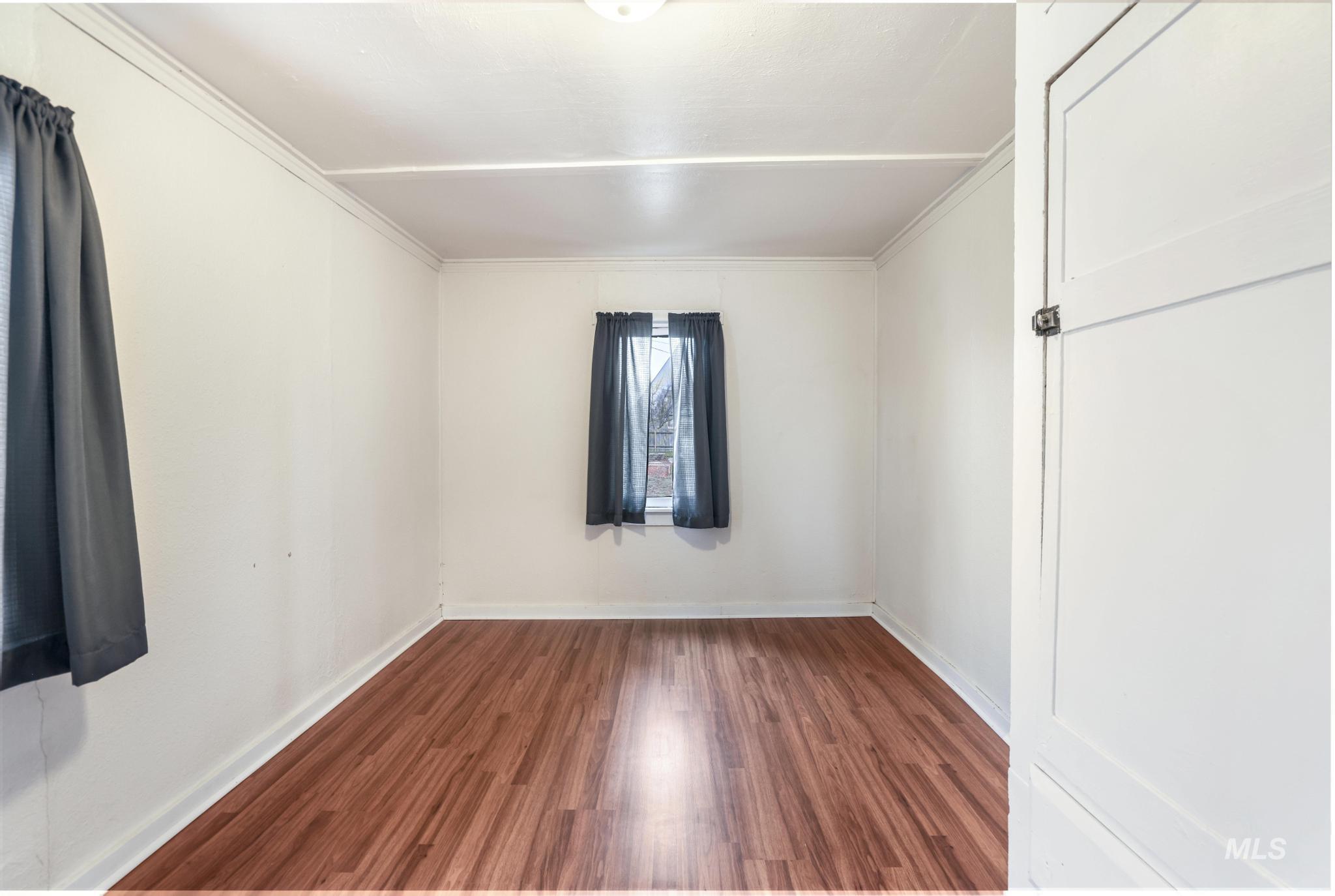 250 Elm Street Twin Falls, ID 83301 - Photo 21 of 28 Spare room featuring dark wood-style flooring and crown molding