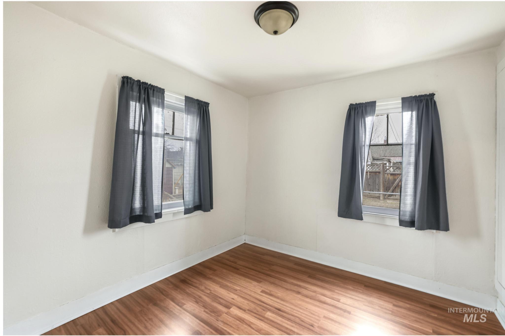 250 Elm Street Twin Falls, ID 83301 - Photo 22 of 28 Empty room featuring wood finished floors and baseboards