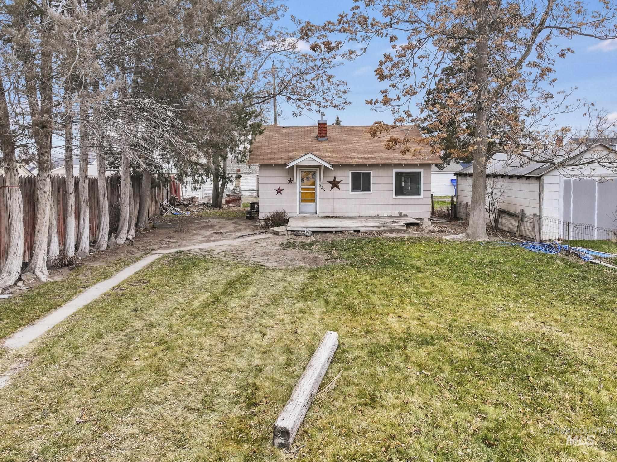 250 Elm Street Twin Falls, ID 83301 - Photo 4 of 28 Back of house with a fenced backyard and a chimney