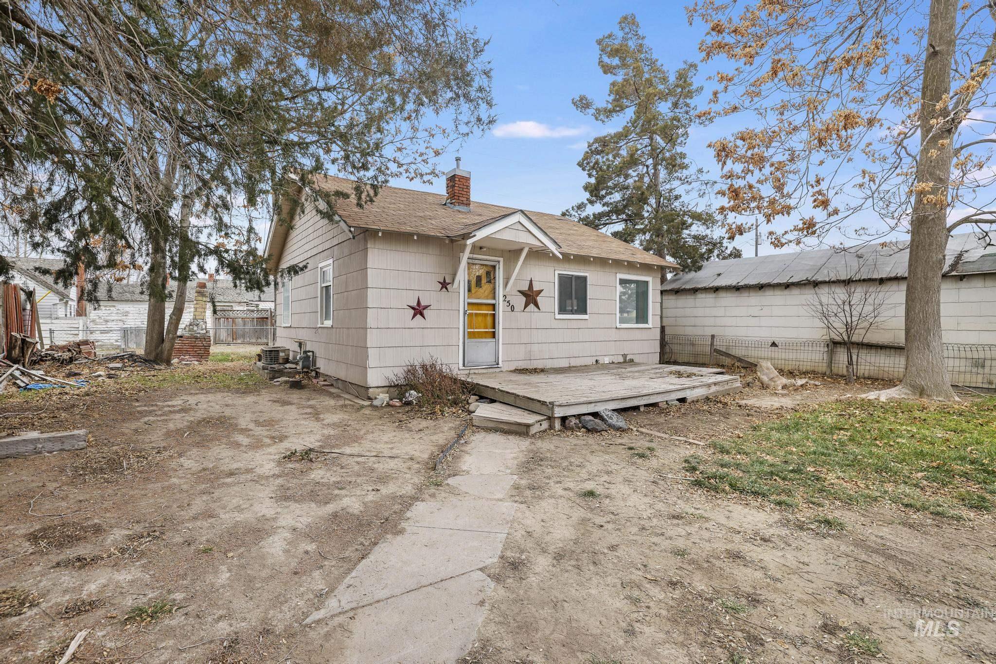 250 Elm Street Twin Falls, ID 83301 - Photo 6 of 28 Rear view of property with a deck, a chimney, and roof with shingles