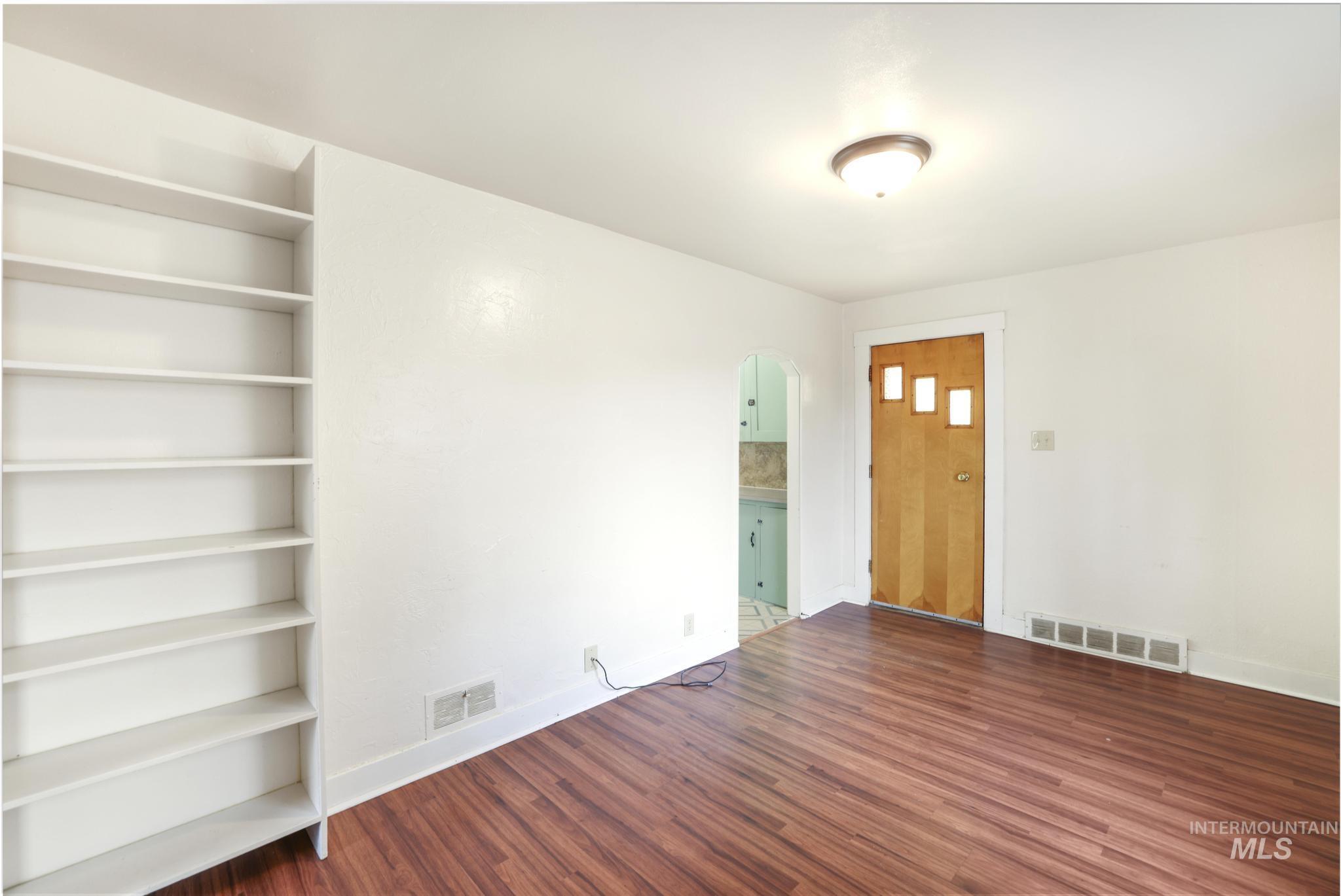 250 Elm Street Twin Falls, ID 83301 - Photo 8 of 28 Foyer entrance with arched walkways and dark wood-style floors