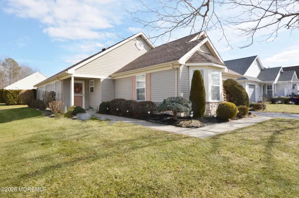 a front view of house with yard and trees around