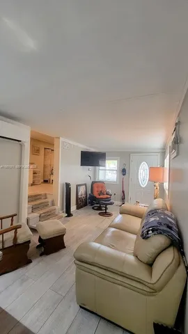 a living room with furniture and a lamp