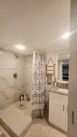 a bathroom with a sink double vanity and shower