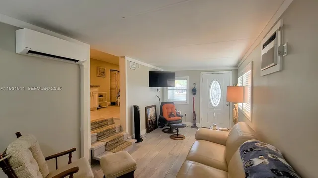 a living room with furniture and a flat screen tv