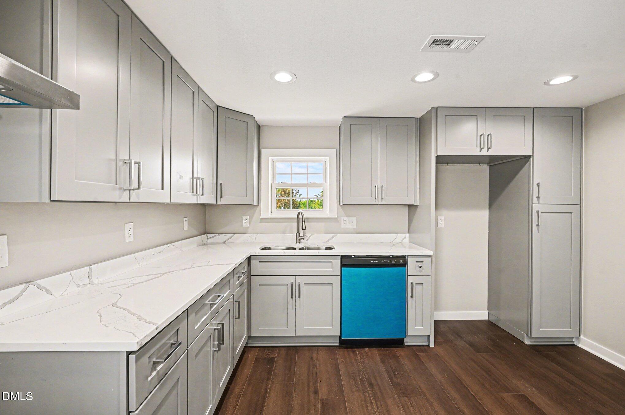 1325 Charlie Carr Road Roxboro, NC 27574 - Photo 14 of 31 a kitchen with a sink cabinets stainless steel appliances and a window