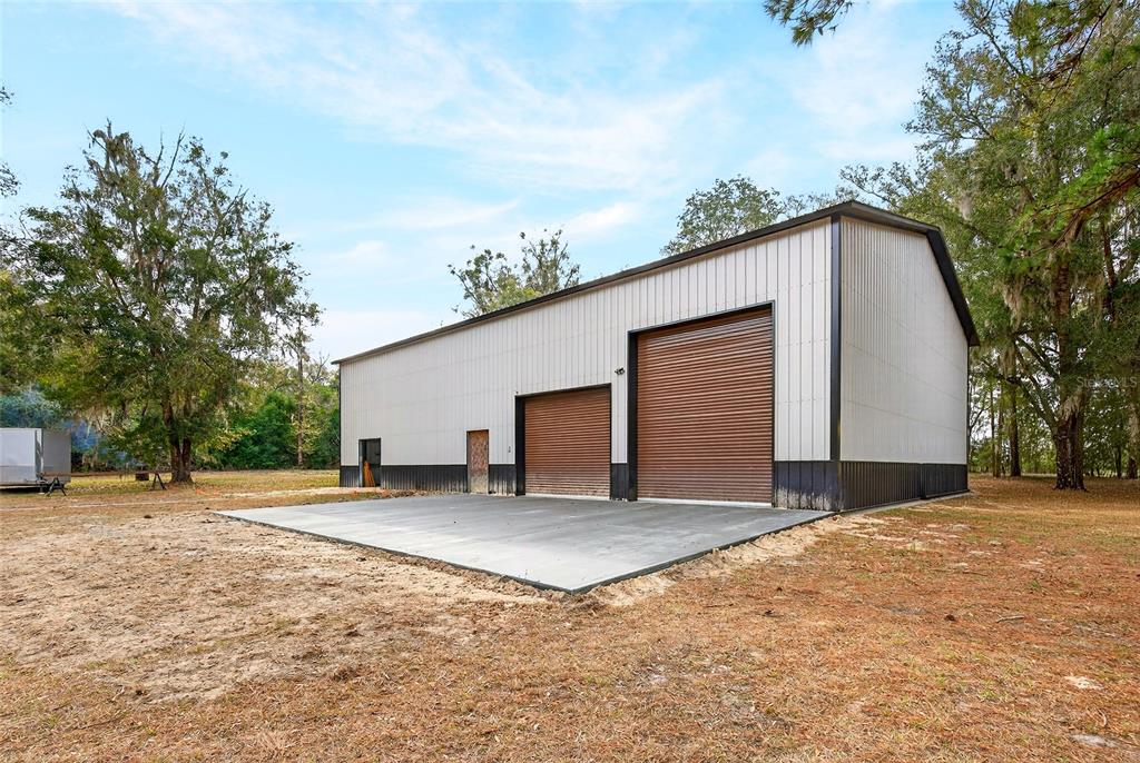 2580 Northeast 140th Street Anthony, FL 32617 - Photo 18 of 25 a view of a house with a yard and garage