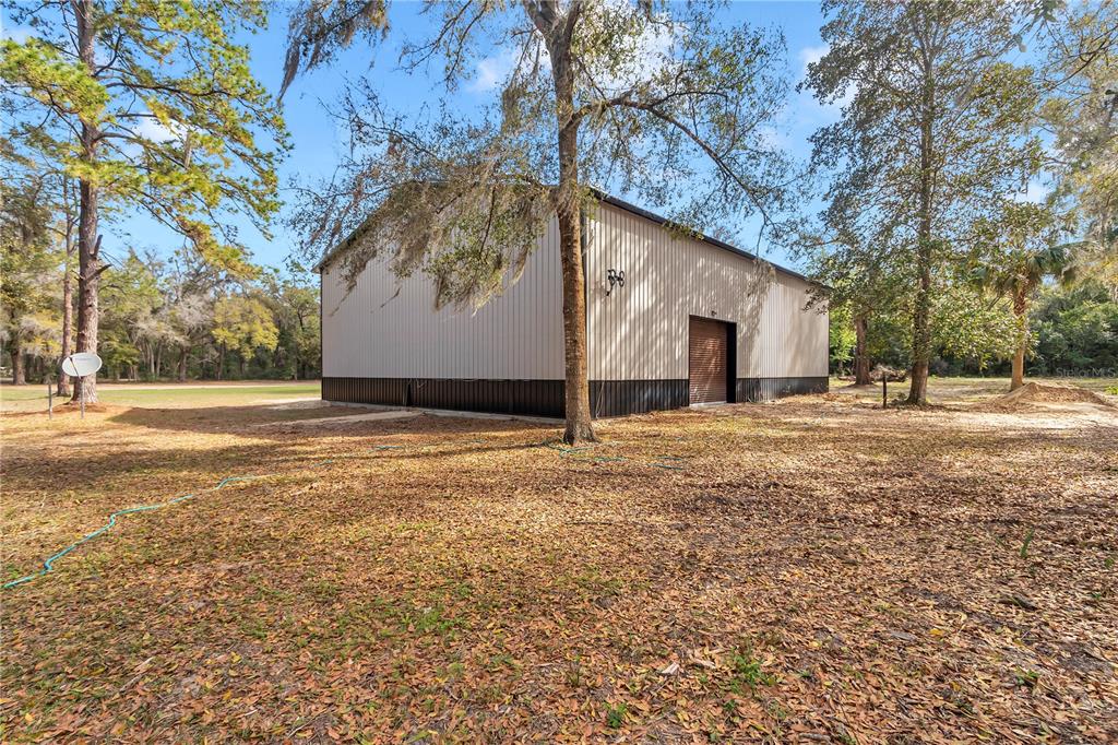 2580 Northeast 140th Street Anthony, FL 32617 - Photo 19 of 25 a backyard of a house with large trees