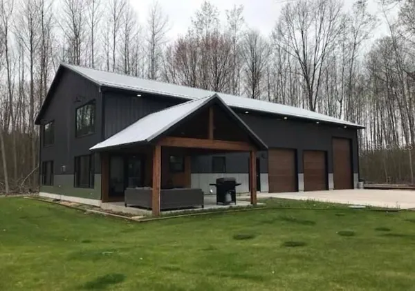 a view of a patio with table and chairs with a yard