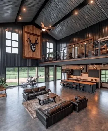 a living room with furniture a wooden floor and next to a window