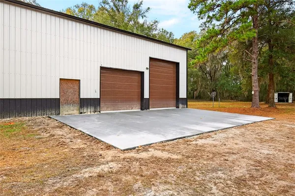 a view of garage with wooden fence