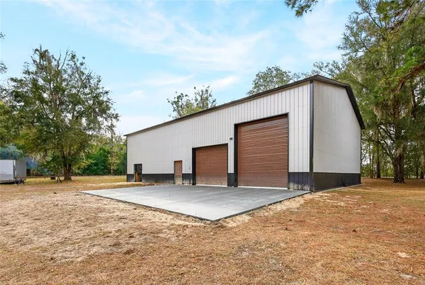 a view of a house with a yard and garage