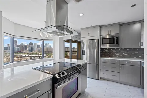 a kitchen with stainless steel appliances granite countertop a stove and a refrigerator