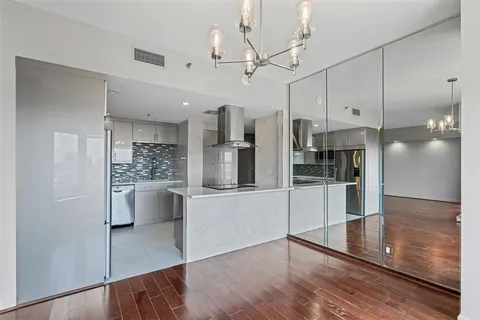 a kitchen with stainless steel appliances a refrigerator and microwave