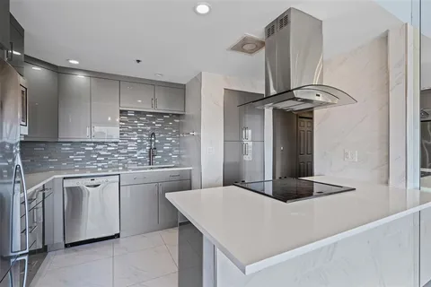 a kitchen with stainless steel appliances a sink and a refrigerator
