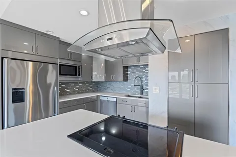 a kitchen with stainless steel appliances a refrigerator and a sink