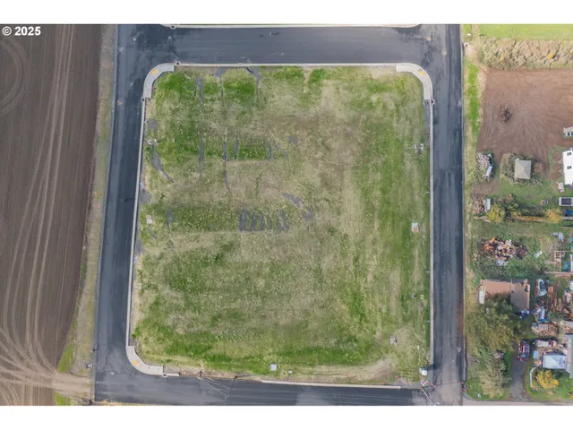 an aerial view of a residential houses with outdoor space and river