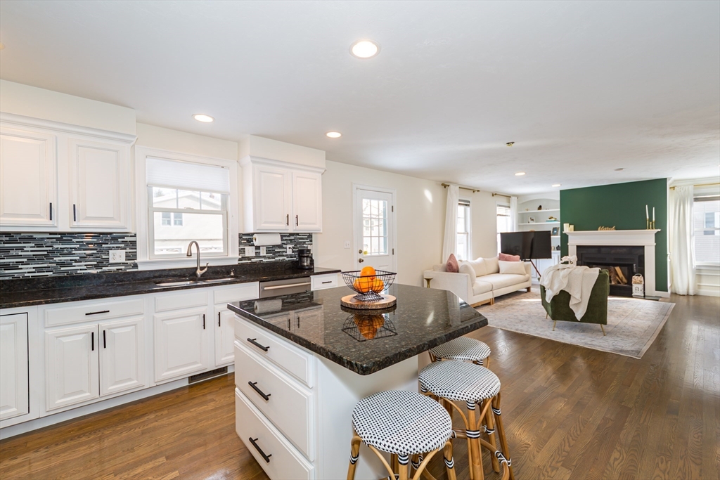 26 Wellesley Avenue, Unit B Natick, MA 01760 - Photo 12 of 34 a kitchen with granite countertop a sink and white cabinets