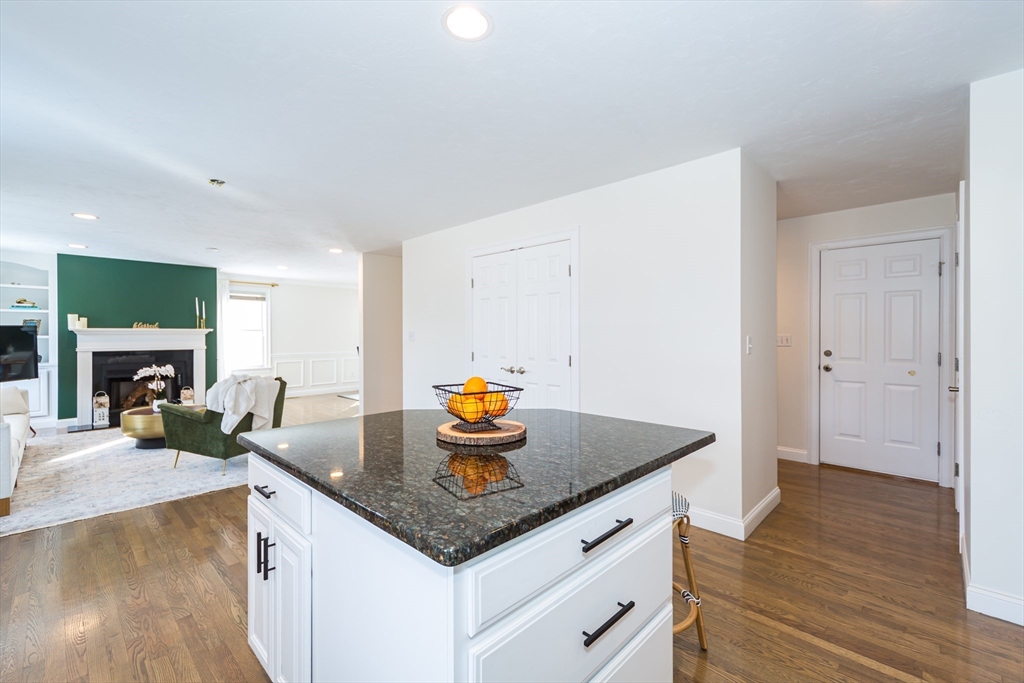 26 Wellesley Avenue, Unit B Natick, MA 01760 - Photo 13 of 34 a kitchen with a sink a stove and wooden floor