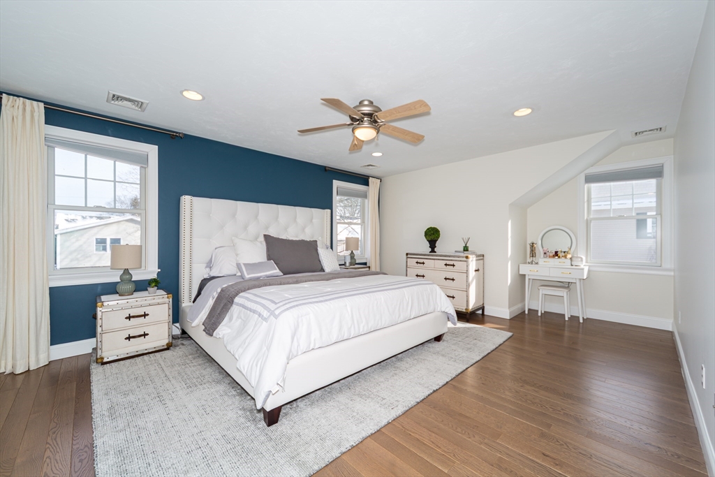 26 Wellesley Avenue, Unit B Natick, MA 01760 - Photo 16 of 34 a bed room with bed and a chandelier