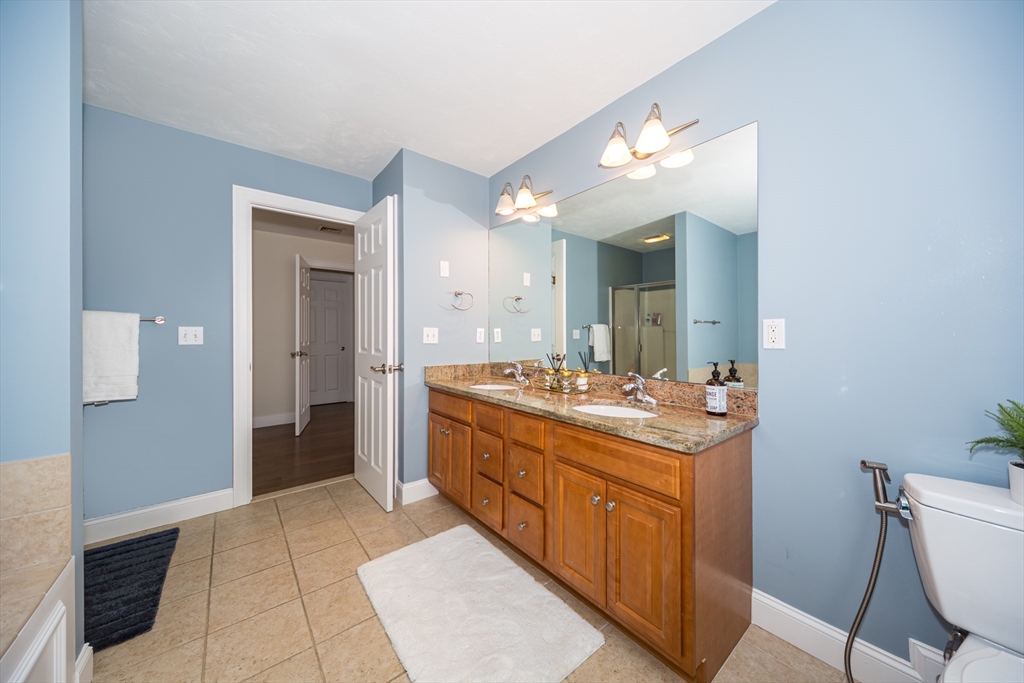 26 Wellesley Avenue, Unit B Natick, MA 01760 - Photo 19 of 34 a bathroom with a sink and a mirror