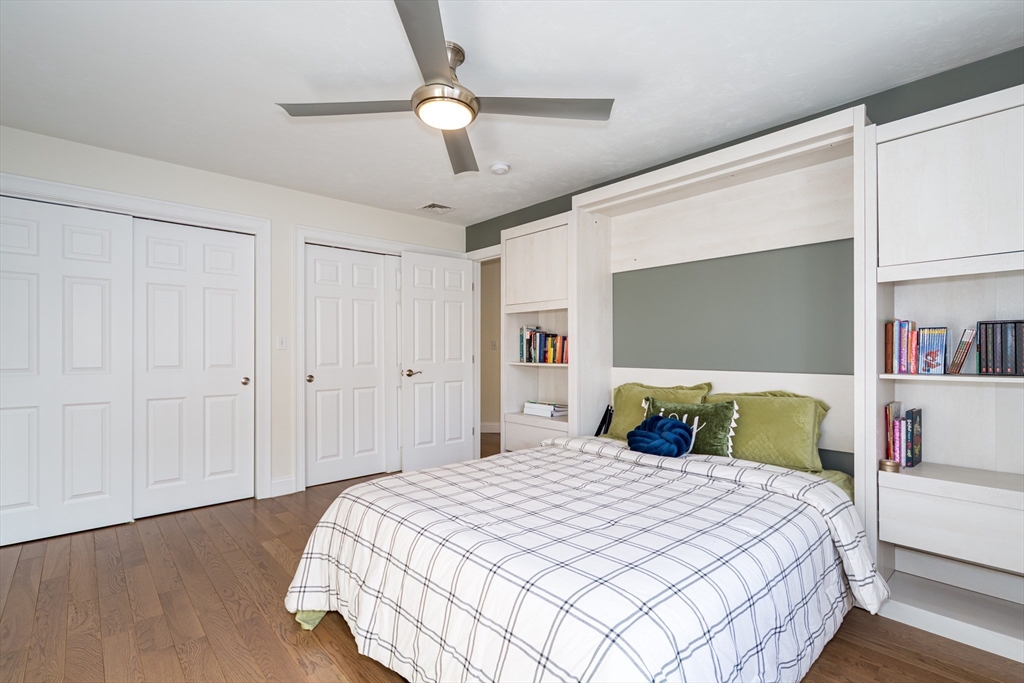 26 Wellesley Avenue, Unit B Natick, MA 01760 - Photo 21 of 34 a bedroom with a large bed and a chandelier