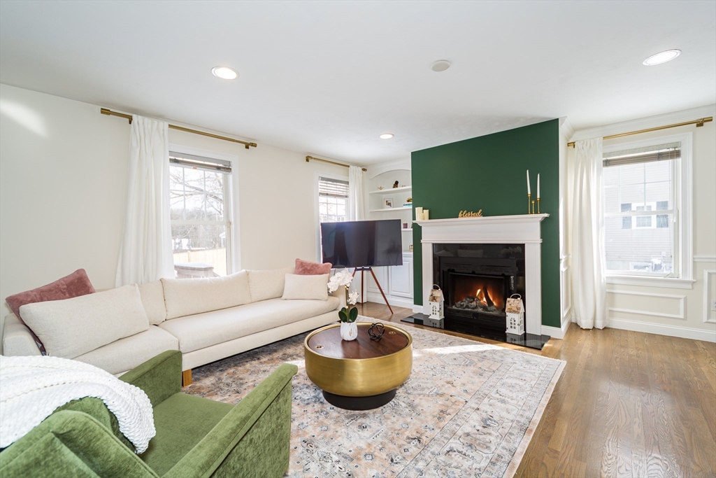 26 Wellesley Avenue, Unit B Natick, MA 01760 - Photo 7 of 34 a living room with furniture and a fireplace