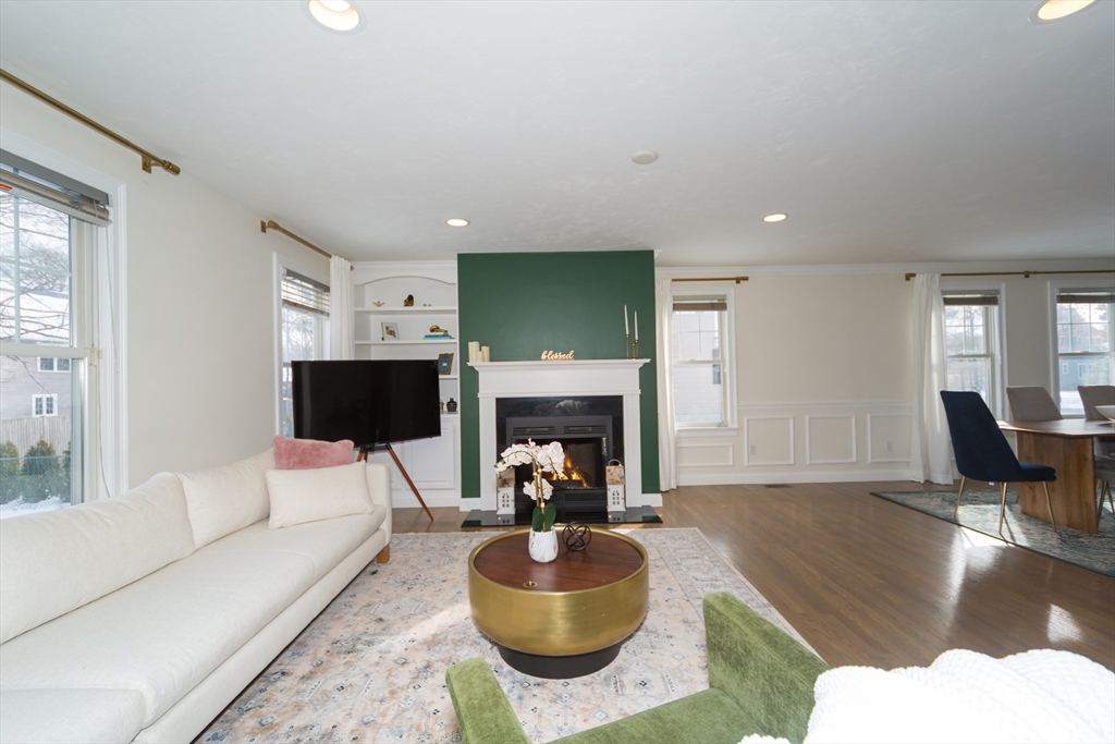 26 Wellesley Avenue, Unit B Natick, MA 01760 - Photo 8 of 34 a living room with furniture a fireplace and a flat screen tv