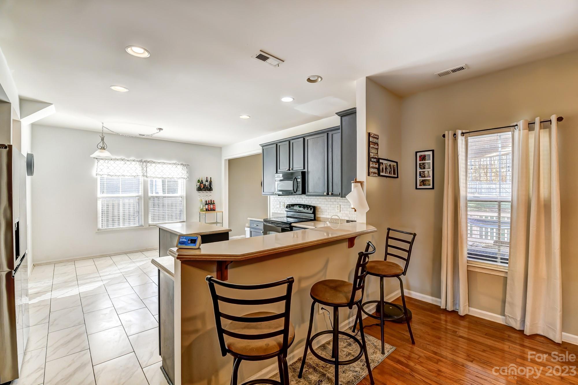 3042 Rhododendron Place Clover, SC 29710 - Photo 12 of 47 a dining hall with stainless steel appliances a dining table and chairs