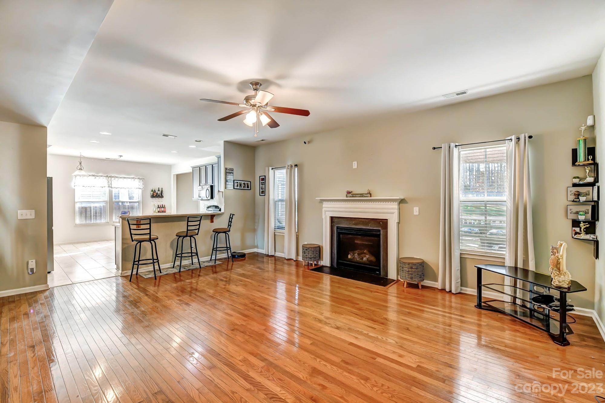 3042 Rhododendron Place Clover, SC 29710 - Photo 13 of 47 a living room with fireplace furniture and a wooden floor