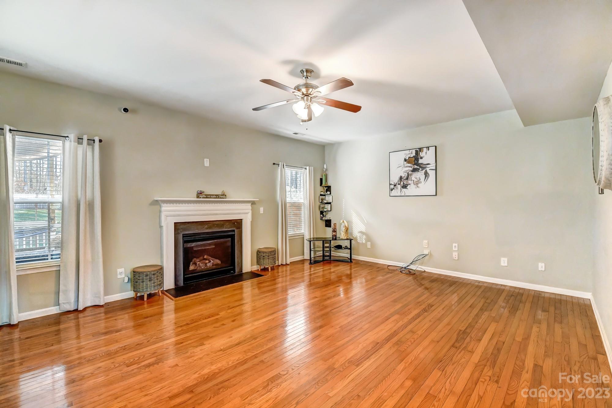 3042 Rhododendron Place Clover, SC 29710 - Photo 15 of 47 a view of empty room with wooden floor and fireplace