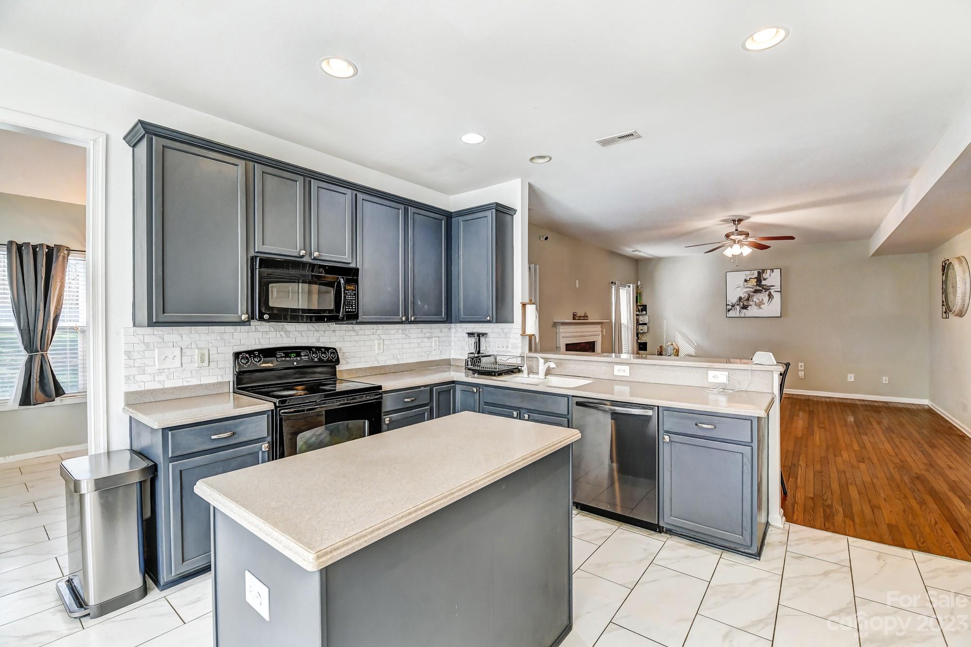 3042 Rhododendron Place Clover, SC 29710 - Photo 21 of 47 a kitchen with a sink a stove top oven and chairs