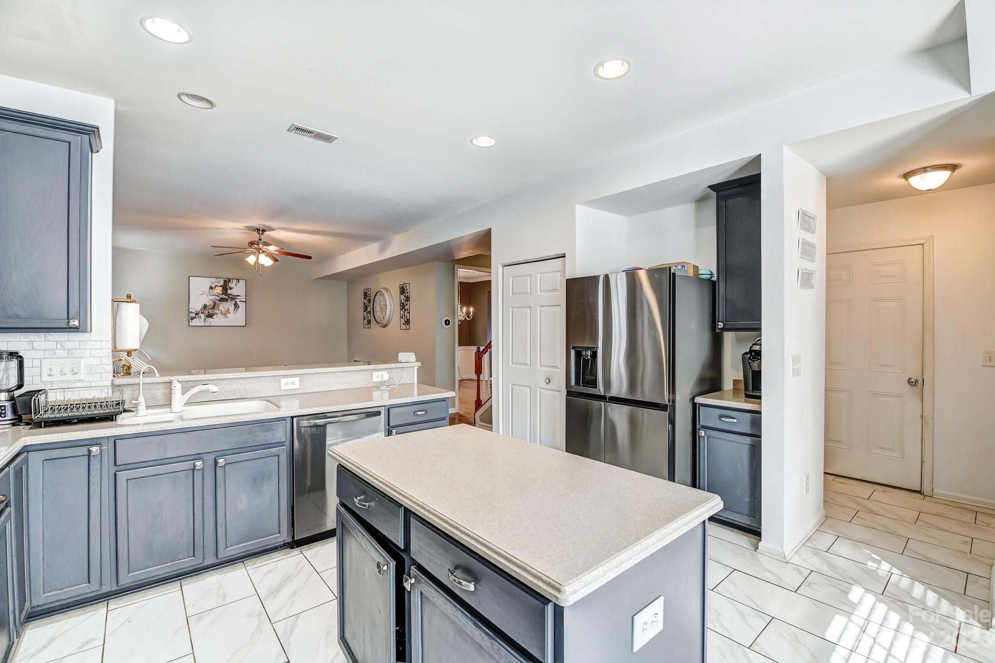 3042 Rhododendron Place Clover, SC 29710 - Photo 22 of 47 a kitchen with a sink a counter top space stainless steel appliances and cabinets