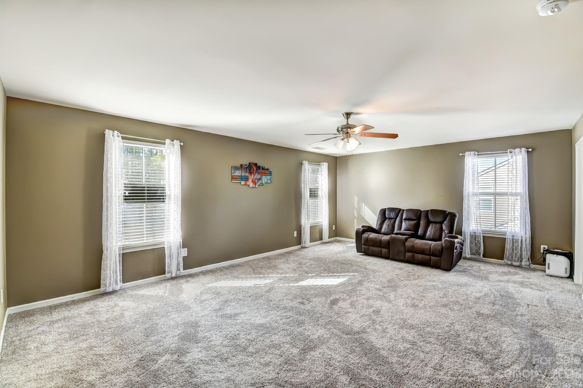 3042 Rhododendron Place Clover, SC 29710 - Photo 28 of 47 a living room with furniture and a chandelier