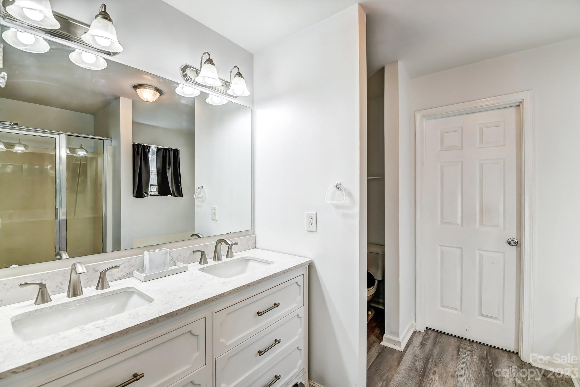 3042 Rhododendron Place Clover, SC 29710 - Photo 31 of 47 a bathroom with a double vanity sink and a mirror