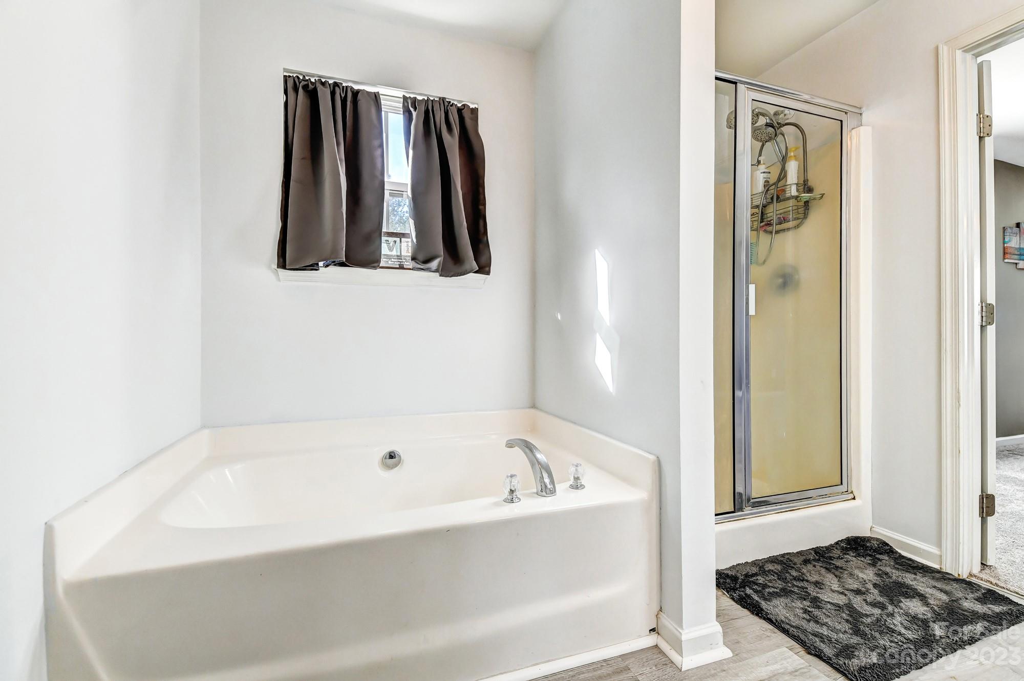 3042 Rhododendron Place Clover, SC 29710 - Photo 32 of 47 a bathroom with a bathtub and a window