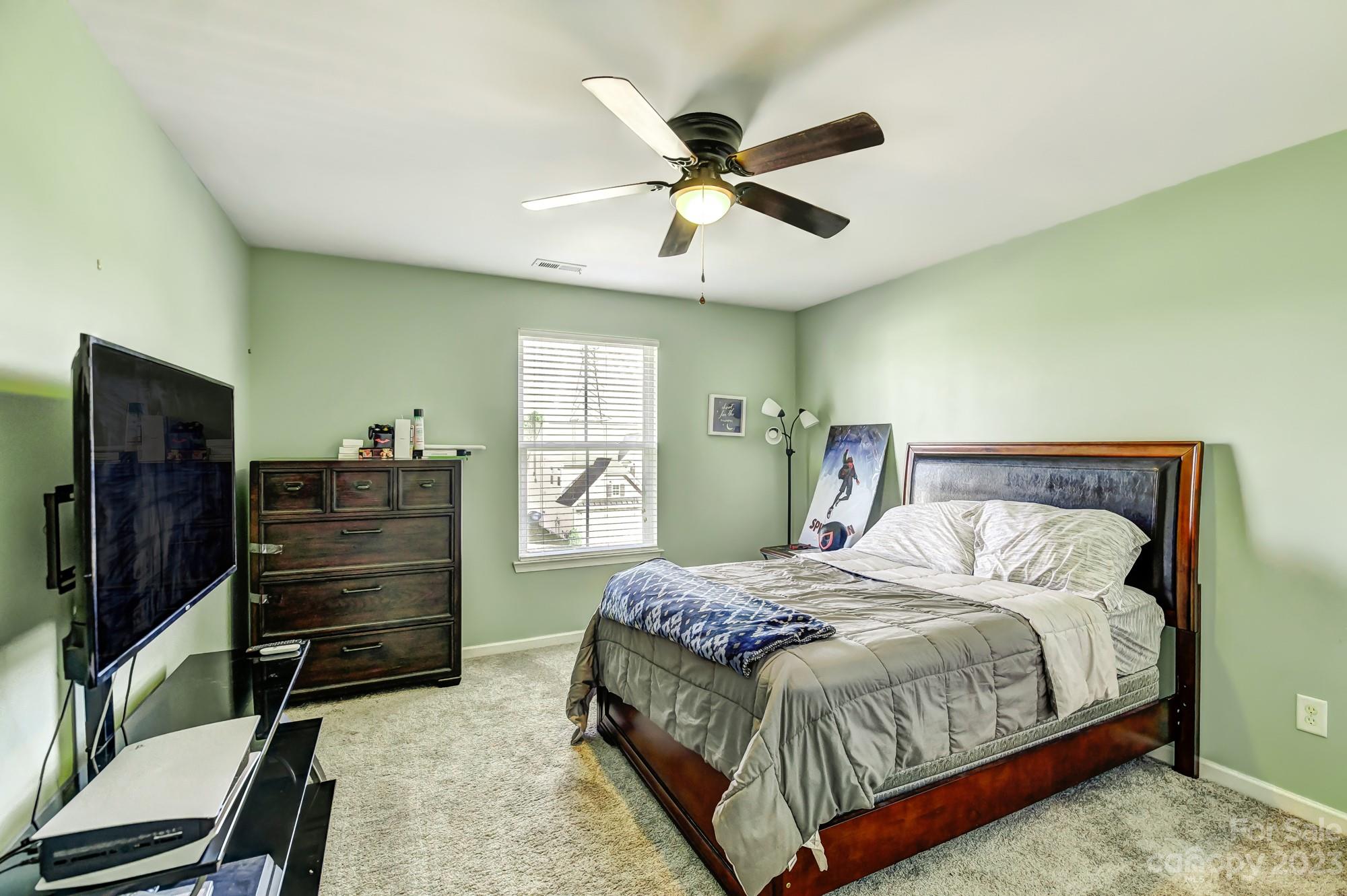 3042 Rhododendron Place Clover, SC 29710 - Photo 37 of 47 a bedroom with a bed and a flat screen tv