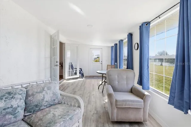 a living room with furniture and a large window