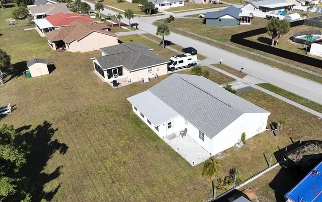 an aerial view of residential houses with outdoor space
