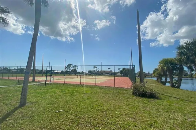 a swimming pool with outdoor seating and yard