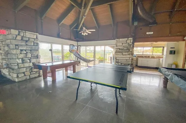 a room with lots of table and a large window