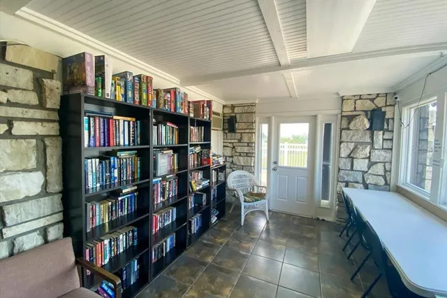 an aerial view of a house with a garden and lake view