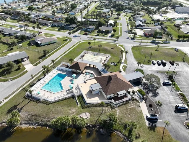 an aerial view of a house with a yard basket ball court and outdoor seating