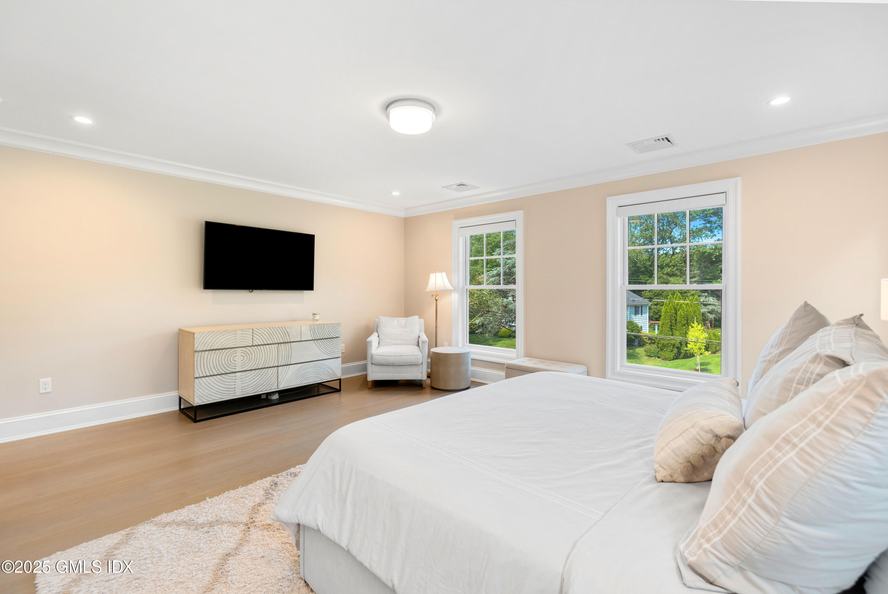 53 Long Meadow Road Riverside, CT 06878 - Photo 13 of 27 a bedroom with a bed a couch and a flat tv screen