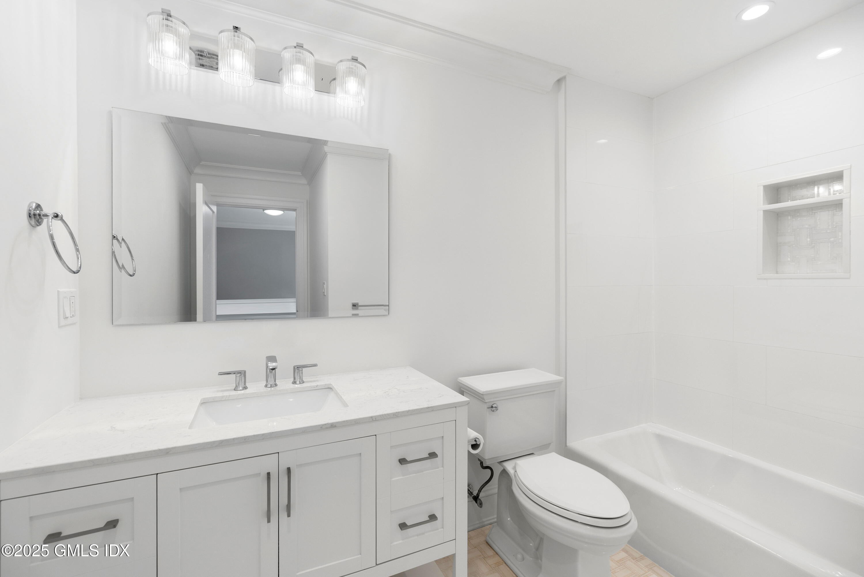 53 Long Meadow Road Riverside, CT 06878 - Photo 18 of 27 a bathroom with a toilet a sink a mirror a bathtub and vanity