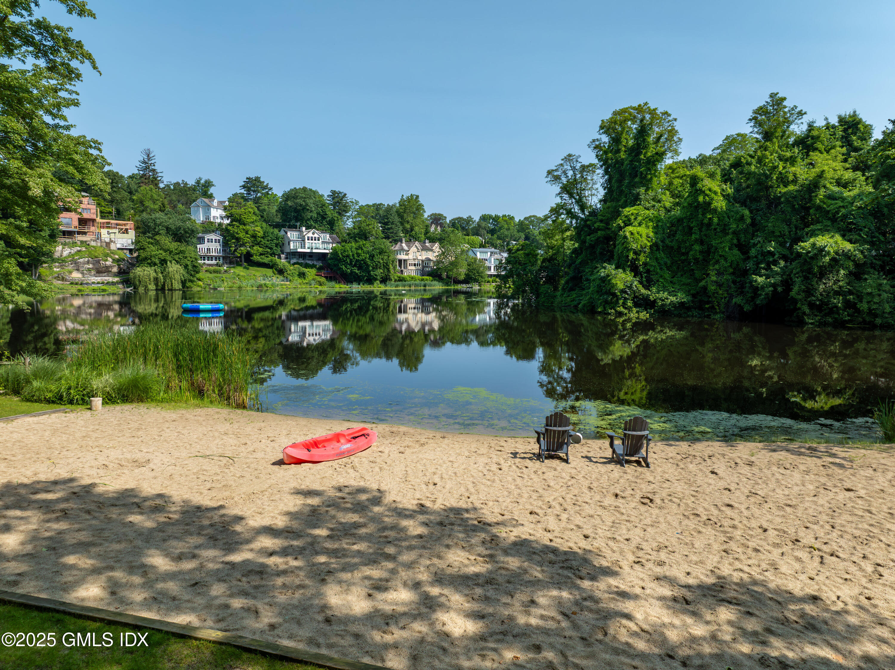 53 Long Meadow Road Riverside, CT 06878 - Photo 26 of 27 a wooden bench with lake view