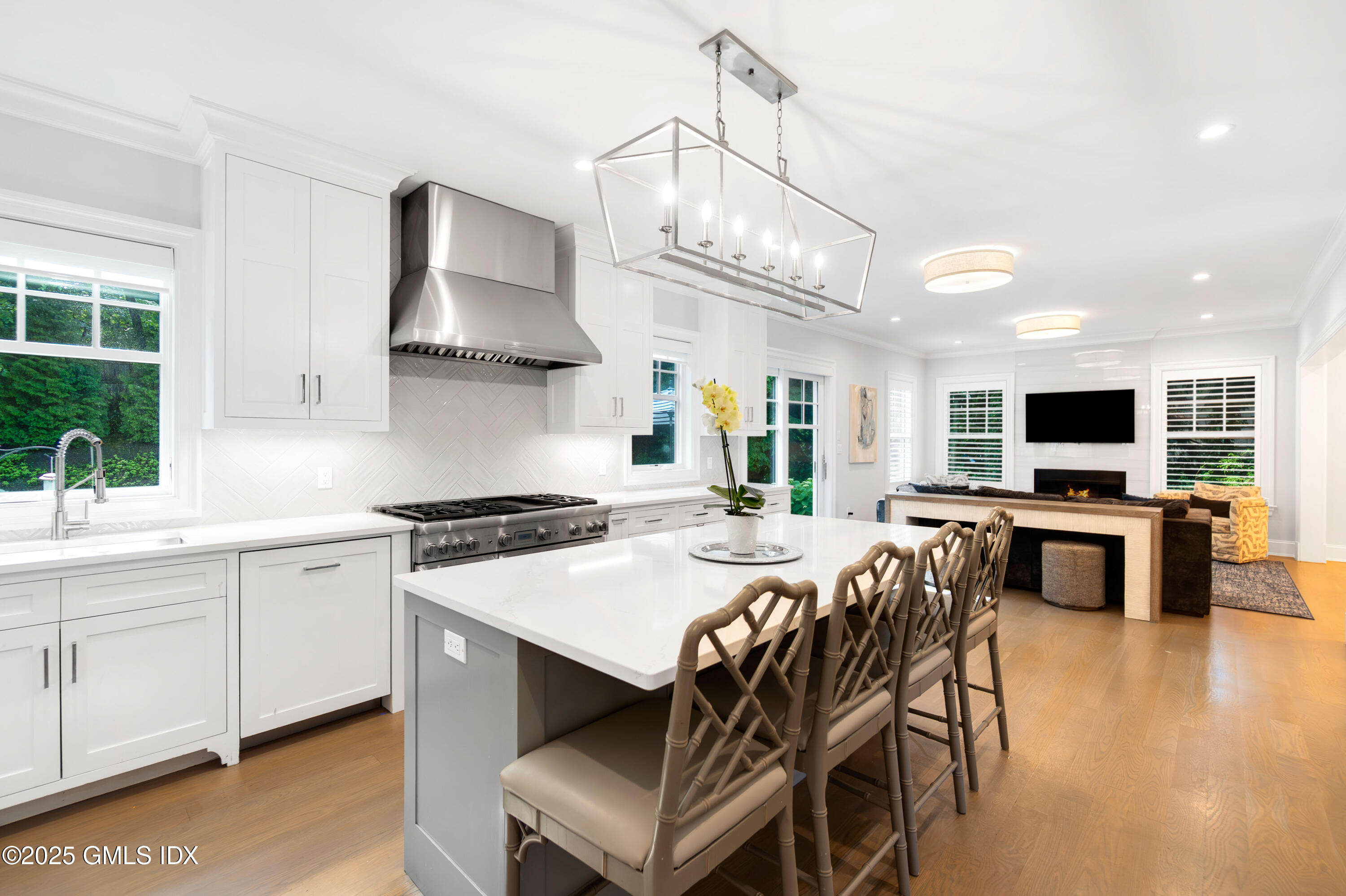 53 Long Meadow Road Riverside, CT 06878 - Photo 3 of 27 a kitchen with stainless steel appliances a stove a sink a microwave a refrigerator and chairs