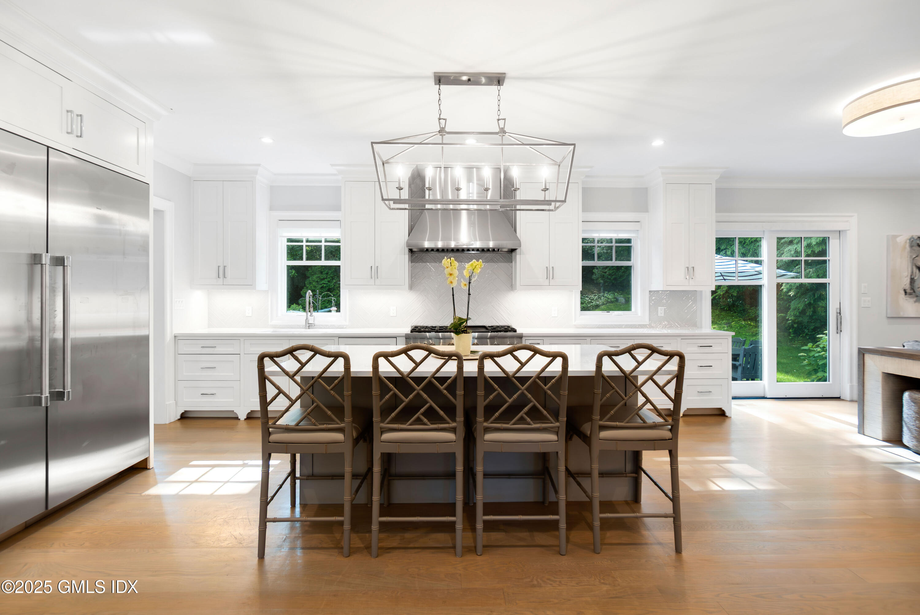 53 Long Meadow Road Riverside, CT 06878 - Photo 4 of 27 a kitchen with a dining table chairs cabinets and stainless steel appliances